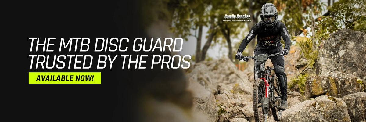 Camilo Sanchez rides a rocky trail wearing a black protective Claw disc guard.